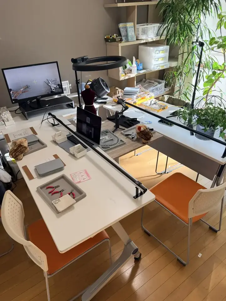 作業机の上の工具トレイとビーズデザインボード。モニターには手元の拡大映像